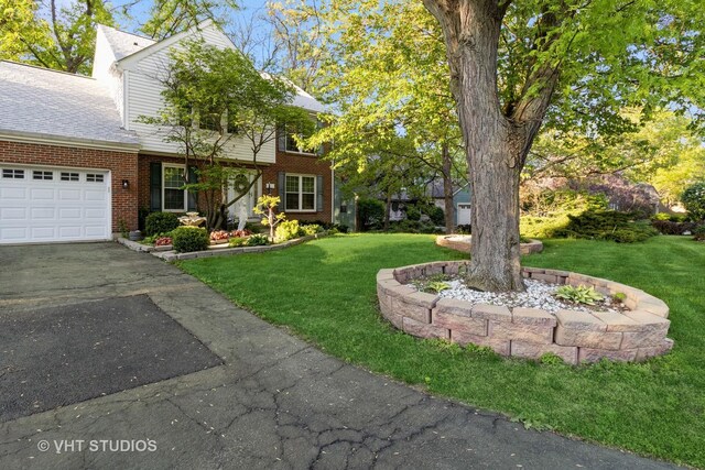772 Red Oak Dr, Bartlett, IL 60103 - view of green lawn featuring asphalt driveway and a garage