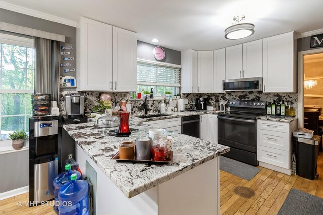 772 Red Oak Dr, Bartlett, IL 60103 - kitchen featuring black appliances, a sink, a peninsula, white cabinets, and crown molding