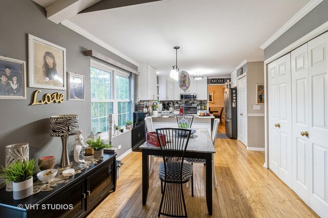 772 Red Oak Dr, Bartlett, IL 60103 - dining space featuring light wood-type flooring, ornamental molding, and baseboards