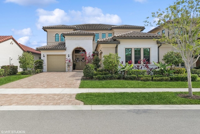 12060 Lake Trail Ln, Parkland, FL 33076 - mediterranean / spanish home featuring a garage, decorative driveway, stucco siding, and a tiled roof