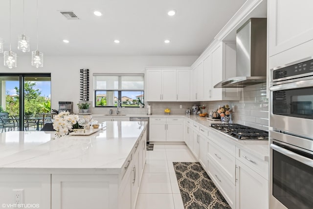 12060 Lake Trail Ln, Parkland, FL 33076 - kitchen featuring wall chimney range hood, appliances with stainless steel finishes, healthy amount of natural light, decorative backsplash, and recessed lighting