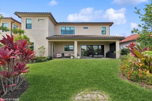 12060 Lake Trail Ln, Parkland, FL 33076 - back of property featuring stucco siding, a lawn, a patio, and a tiled roof