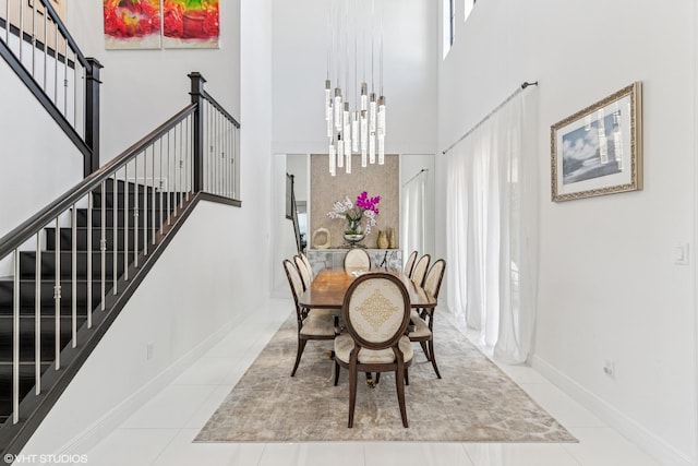 12060 Lake Trail Ln, Parkland, FL 33076 - dining room featuring a high ceiling, stairway, baseboards, and tile patterned floors