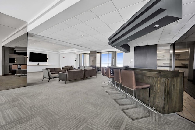indoor dry bar with light colored carpet and recessed lighting