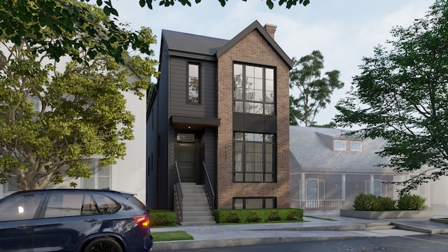 view of front of property featuring brick siding and a chimney