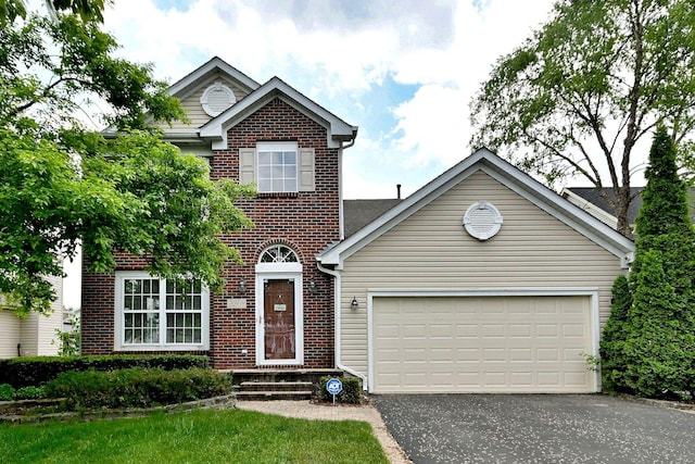 2209 Beaumont Ct, Aurora, IL 60502 - traditional-style home with brick siding, asphalt driveway, and a garage