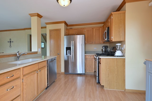 2209 Beaumont Ct, Aurora, IL 60502 - kitchen featuring stainless steel appliances, a sink, light wood-style flooring, light countertops, and crown molding
