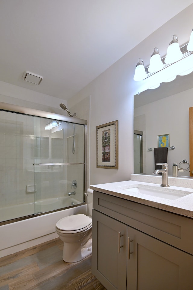 2209 Beaumont Ct, Aurora, IL 60502 - bathroom with toilet, vanity, shower / bath combination with glass door, and wood finished floors