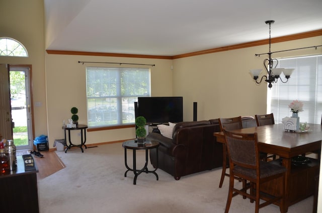 2209 Beaumont Ct, Aurora, IL 60502 - dining area featuring a chandelier, light carpet, healthy amount of natural light, crown molding, and baseboards