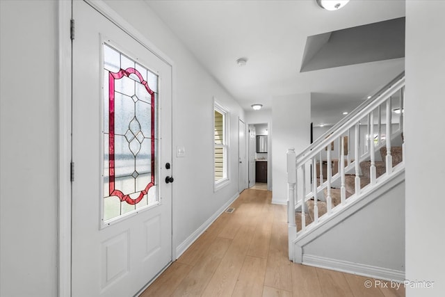 9 N Walnut Ct, Streamwood, IL 60107 - entrance foyer featuring stairway, light wood-style flooring, baseboards, and plenty of natural light