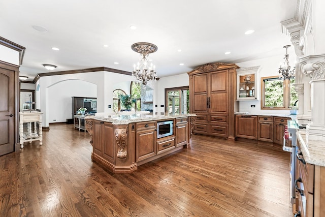 3113 Turnberry Rd, Saint Charles, IL 60174 - kitchen featuring appliances with stainless steel finishes, brown cabinets, a chandelier, arched walkways, and recessed lighting
