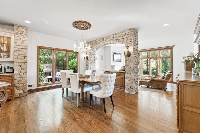 3113 Turnberry Rd, Saint Charles, IL 60174 - dining room with a chandelier, arched walkways, light wood-style flooring, decorative columns, and healthy amount of natural light