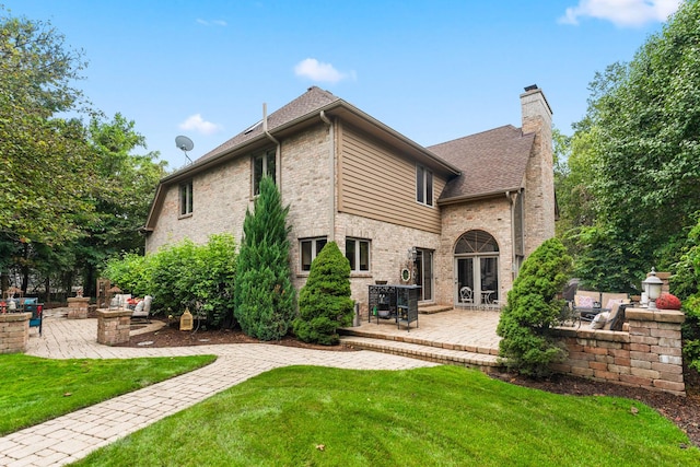 3113 Turnberry Rd, Saint Charles, IL 60174 - back of house featuring a patio, a chimney, a fire pit, and a lawn