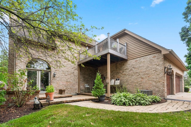 3113 Turnberry Rd, Saint Charles, IL 60174 - back of house featuring a balcony, brick siding, an attached garage, and a yard