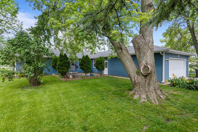 849 N Piatt St, Bement, IL 61813 - view of green lawn with a garage