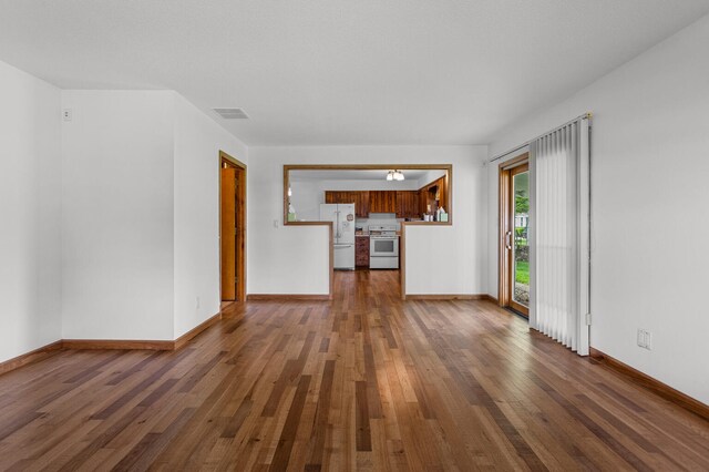 849 N Piatt St, Bement, IL 61813 - unfurnished living room featuring hardwood / wood-style floors and baseboards