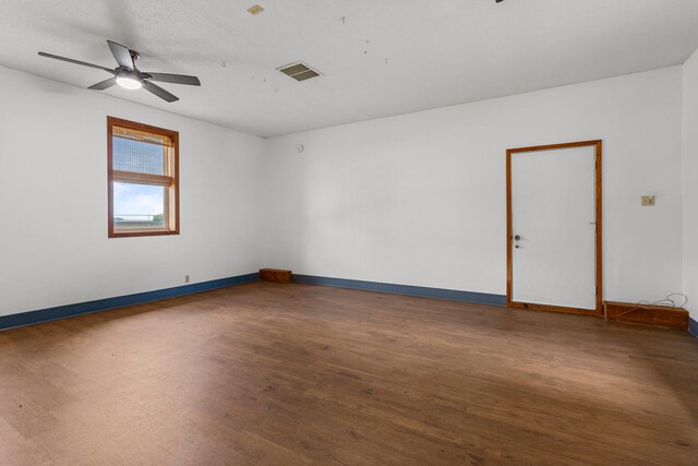 849 N Piatt St, Bement, IL 61813 - empty room featuring wood finished floors, baseboards, and ceiling fan