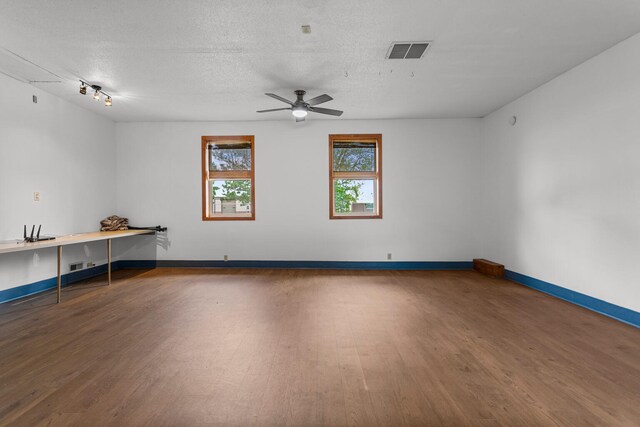 849 N Piatt St, Bement, IL 61813 - unfurnished room with wood finished floors, a textured ceiling, baseboards, and a ceiling fan