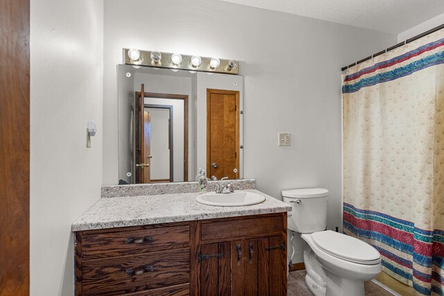 849 N Piatt St, Bement, IL 61813 - bathroom featuring toilet, vanity, a shower with curtain, and tile patterned flooring