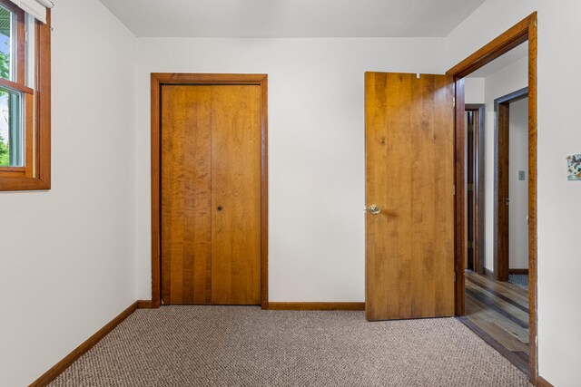 849 N Piatt St, Bement, IL 61813 - unfurnished bedroom with carpet flooring, baseboards, and a closet