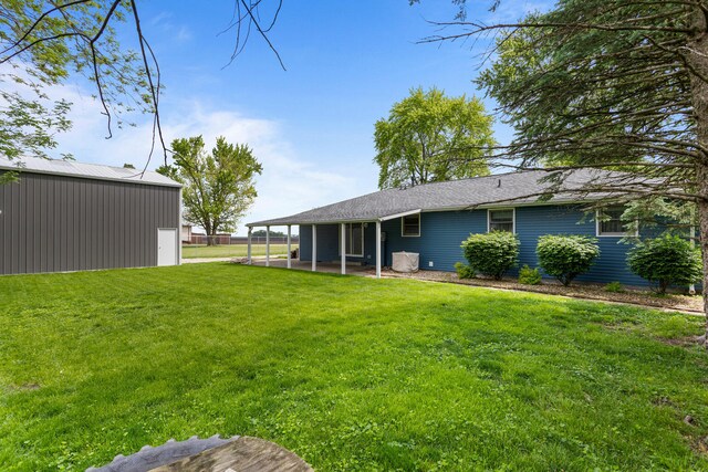 849 N Piatt St, Bement, IL 61813 - view of grassy yard with a pole building, an outbuilding, and a patio