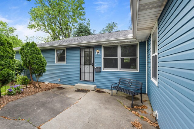849 N Piatt St, Bement, IL 61813 - doorway to property with a patio area and a shingled roof