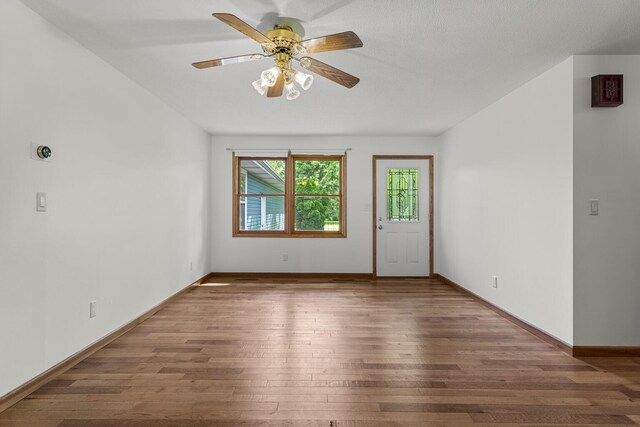 849 N Piatt St, Bement, IL 61813 - spare room featuring hardwood / wood-style floors, a ceiling fan, and baseboards