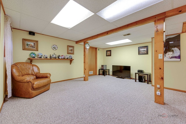 living area with carpet floors, baseboards, and a drop ceiling