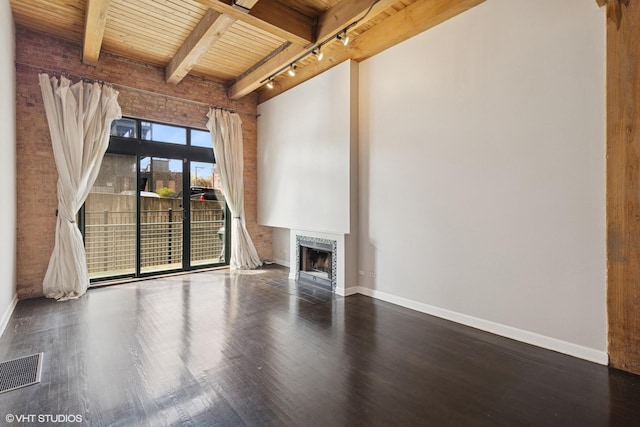 unfurnished living room with wooden ceiling, wood finished floors, baseboards, beamed ceiling, and a fireplace