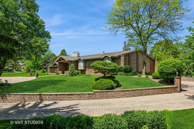 30W010 Smith Rd, West Chicago, IL 60185 - view of front of home featuring brick siding, a chimney, and a front lawn