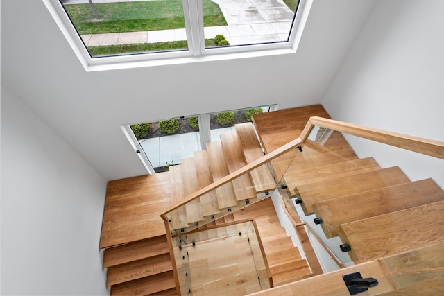 staircase with a skylight and plenty of natural light