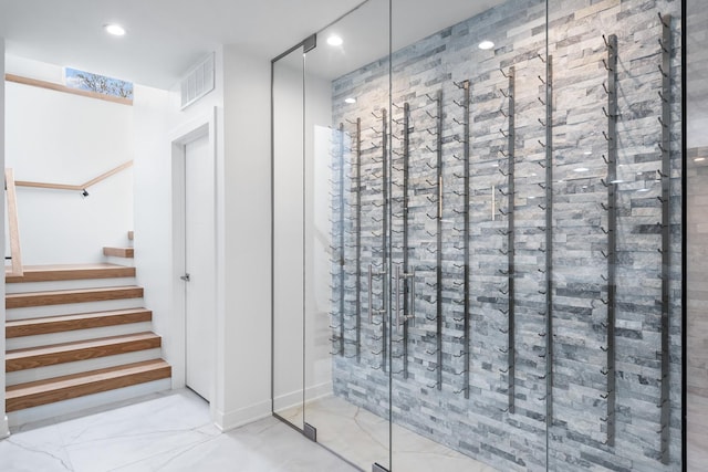 wine room featuring marble finish flooring and recessed lighting