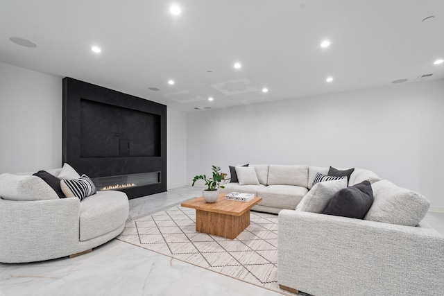 living area with light marble finish floors and recessed lighting