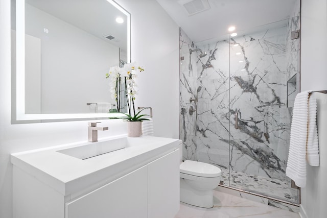 bathroom with marble finish floors, a marble finish shower, toilet, recessed lighting, and vanity
