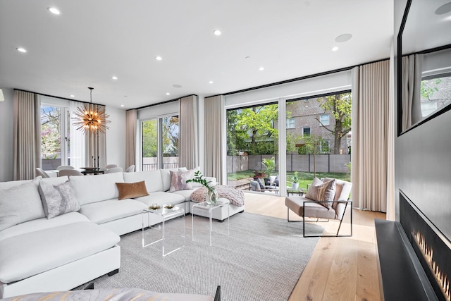living area featuring wood finished floors, recessed lighting, and a chandelier