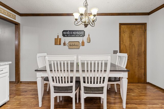 2717 E Main St, Decatur, IL 62521 - dining room with ornamental molding, a chandelier, a textured ceiling, light wood-type flooring, and baseboards