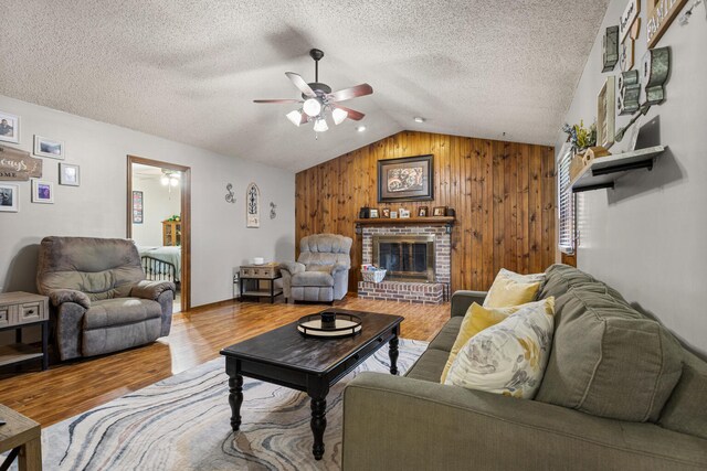 2717 E Main St, Decatur, IL 62521 - living area featuring a ceiling fan, lofted ceiling, wood walls, wood finished floors, and a fireplace