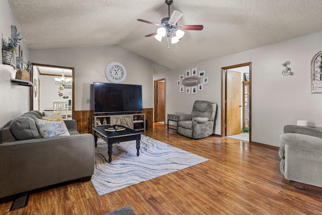 2717 E Main St, Decatur, IL 62521 - living room featuring wood finished floors, a chandelier, a ceiling fan, lofted ceiling, and a textured ceiling