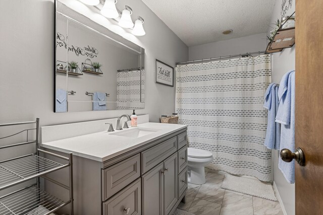 2717 E Main St, Decatur, IL 62521 - bathroom featuring vanity, toilet, a textured ceiling, marble finish floors, and curtained shower