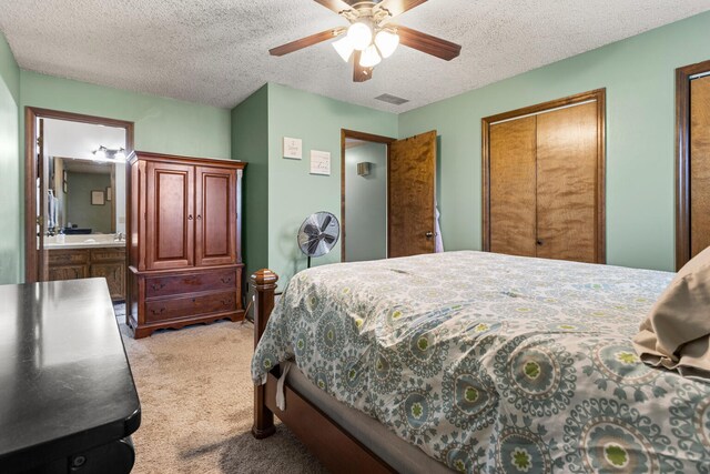 2717 E Main St, Decatur, IL 62521 - bedroom with light carpet, a textured ceiling, a ceiling fan, and multiple closets