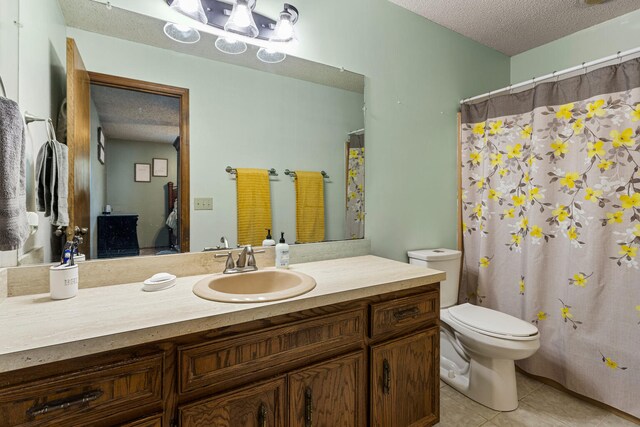 2717 E Main St, Decatur, IL 62521 - bathroom with a textured ceiling, tile patterned floors, toilet, vanity, and a shower with shower curtain