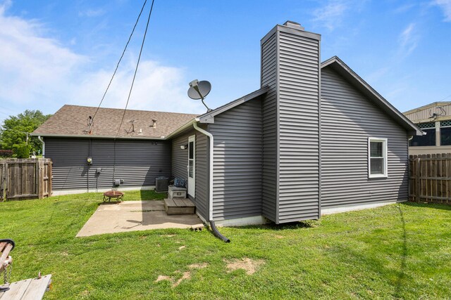 2717 E Main St, Decatur, IL 62521 - rear view of house with a patio area, a chimney, and central AC