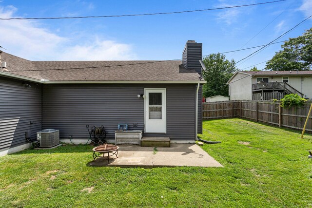 2717 E Main St, Decatur, IL 62521 - rear view of property with an outdoor fire pit, a chimney, central AC unit, and a patio area