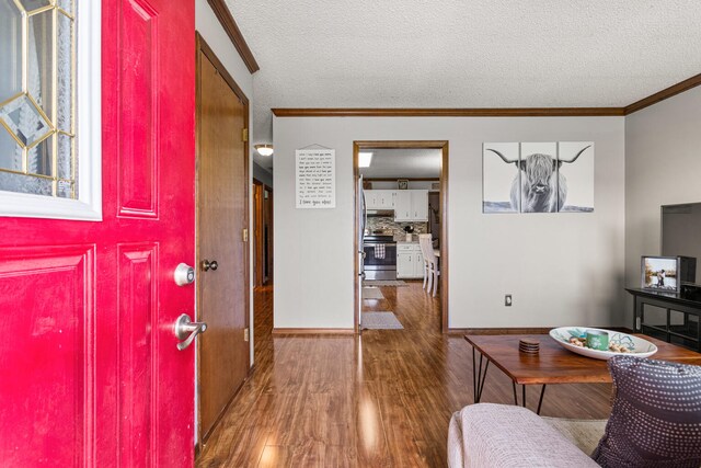 2717 E Main St, Decatur, IL 62521 - entryway with wood finished floors, ornamental molding, a textured ceiling, and baseboards