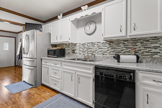 2717 E Main St, Decatur, IL 62521 - kitchen featuring dishwasher, stainless steel microwave, a sink, crown molding, and light wood finished floors