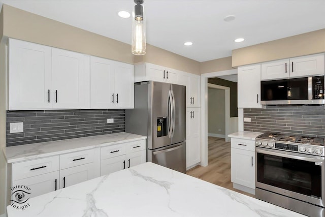 2639 E Shady Grove Ct, Crete, IL 60417 - kitchen with appliances with stainless steel finishes, white cabinetry, light wood finished floors, decorative backsplash, and light stone countertops