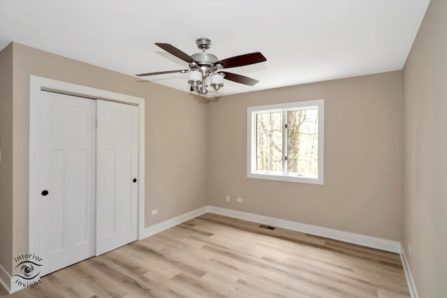 2639 E Shady Grove Ct, Crete, IL 60417 - unfurnished bedroom featuring light wood finished floors, a closet, baseboards, and a ceiling fan