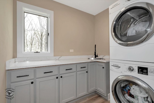 2639 E Shady Grove Ct, Crete, IL 60417 - laundry area featuring estacked washer and dryer, cabinet space, and light wood-style floors