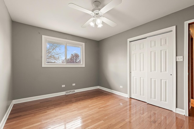 6407 182nd St, Tinley Park, IL 60477 - unfurnished bedroom with light wood finished floors, a closet, baseboards, and a ceiling fan