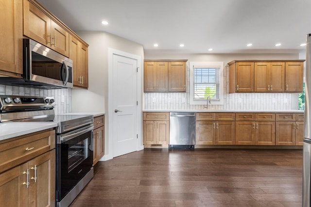 2012 Spruce Ln, Monticello, IL 61856 - kitchen with appliances with stainless steel finishes, dark wood-type flooring, backsplash, light countertops, and recessed lighting